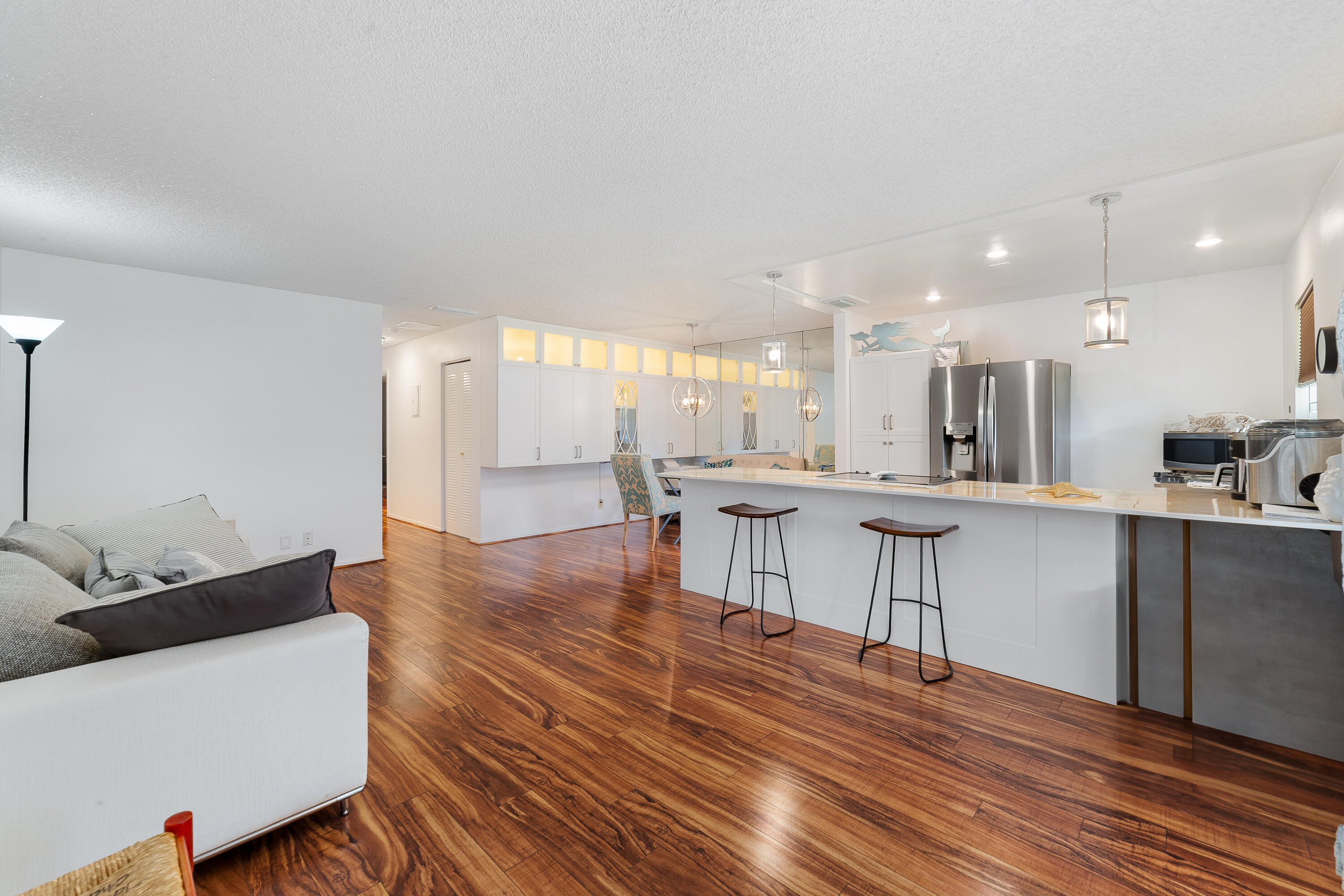3331 Valley Road, Unit C Boynton Beach, FL 33435 - Photo 3 of 28 a living room with kitchen island and a wooden floor