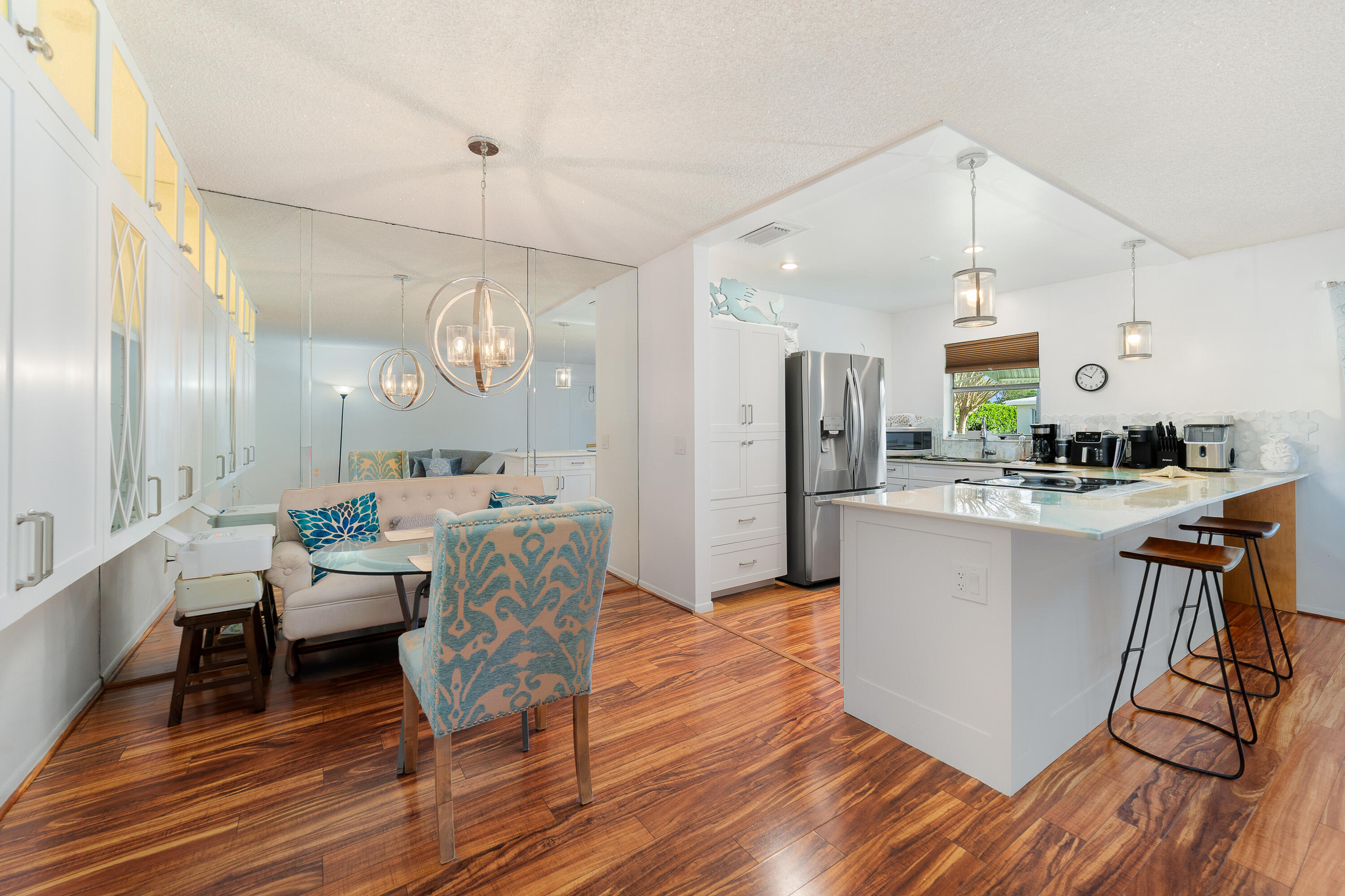 3331 Valley Road, Unit C Boynton Beach, FL 33435 - Photo 6 of 28 a living room with furniture a dining table wooden floor and a fireplace