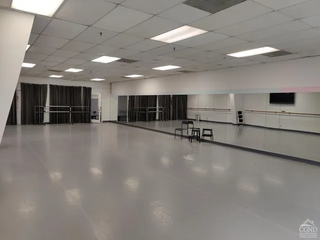 a view of a room with gym equipment and a large window