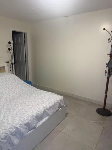a bed sitting in a bedroom and closet