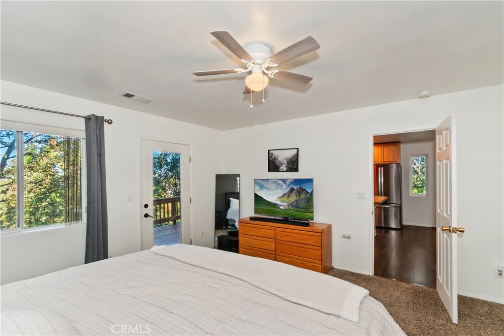 198 Pine Ridge Road Crestline, CA 92325 - Photo 11 of 45 a bedroom with a bed and a flat screen tv