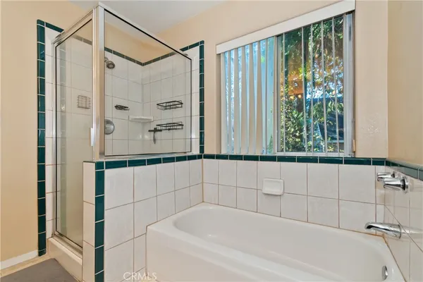 a bathroom with a bathtub and shower