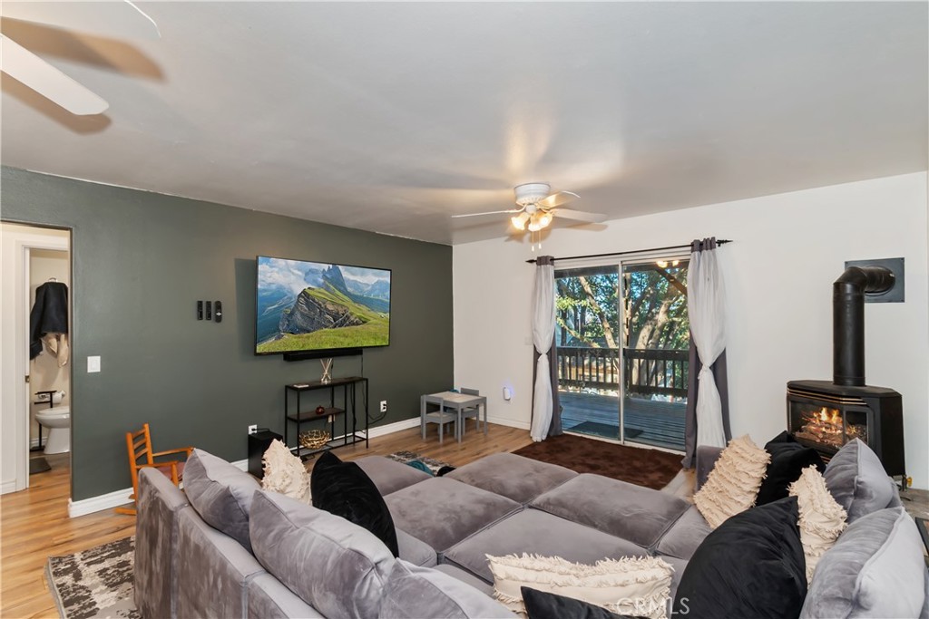 198 Pine Ridge Road Crestline, CA 92325 - Photo 15 of 45 a living room with furniture a chandelier and a flat screen tv