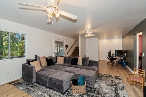 a living room with furniture and a chandelier