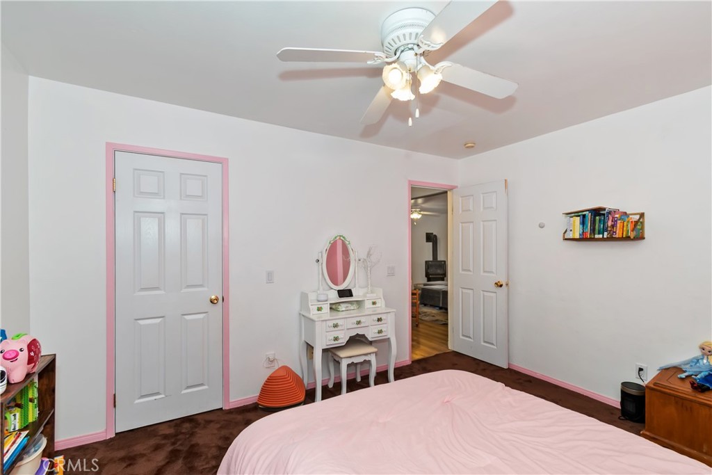 198 Pine Ridge Road Crestline, CA 92325 - Photo 22 of 45 a bedroom with a bed and a chandelier