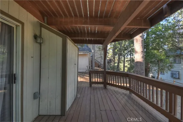 a view of a balcony with wooden floor