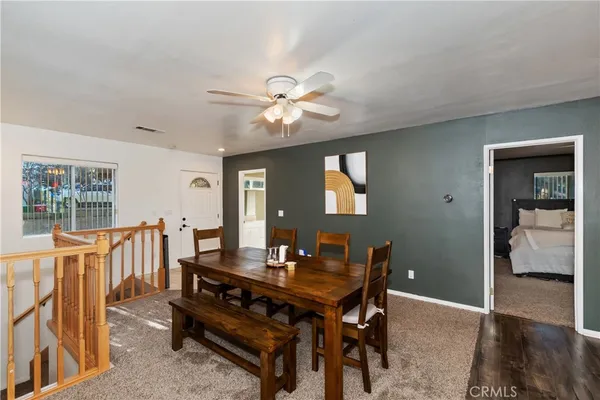a dining room with furniture a rug and a chandelier