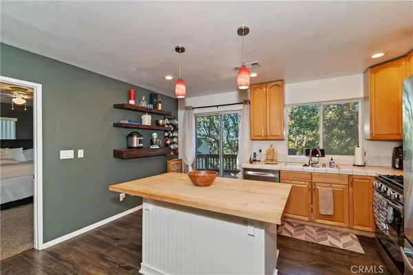 a kitchen that has a sink and a stove in it