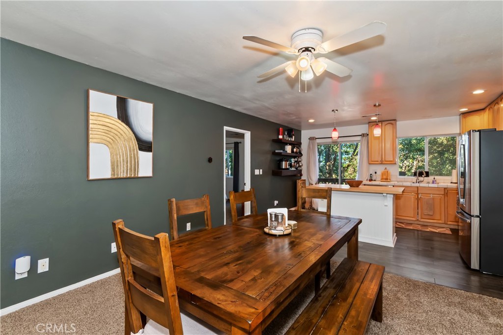 198 Pine Ridge Road Crestline, CA 92325 - Photo 4 of 45 a dining room with wooden floor and a chandelier