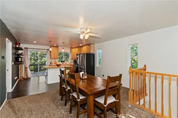 a dining room with furniture and wooden floor