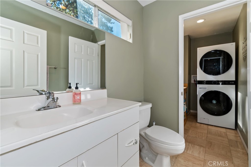 198 Pine Ridge Road Crestline, CA 92325 - Photo 7 of 45 a bathroom with a sink a toilet and a mirror