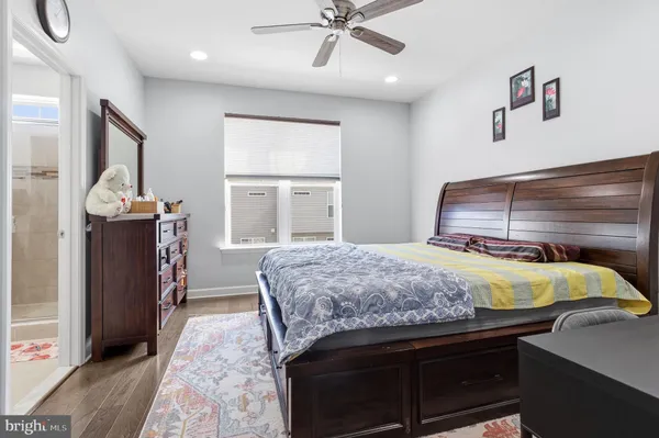 a bedroom with a bed and a dresser