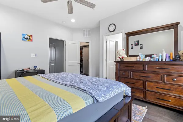 a bedroom with a bed and a dresser