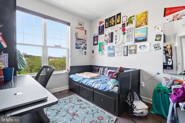 a bedroom with furniture and a large window