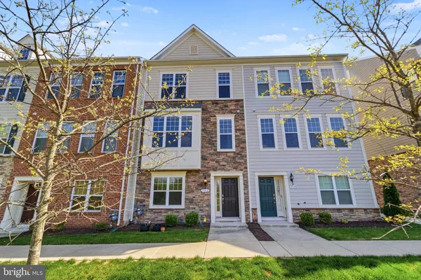 front view of a brick house with a yard