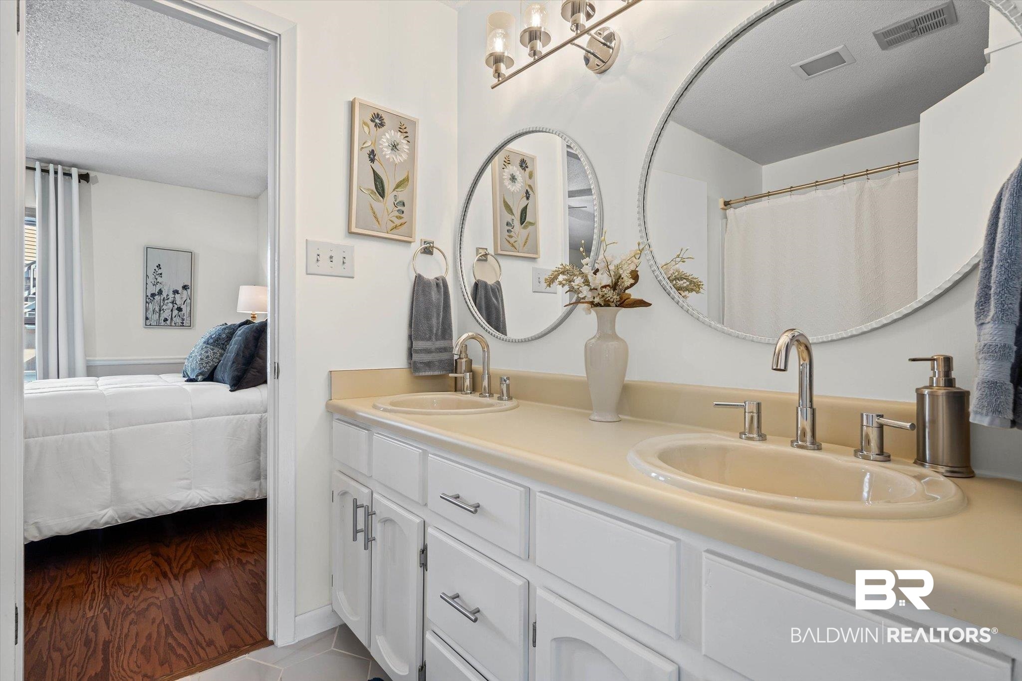 4567 Pine Avenue Saraland, AL 36571 - Photo 17 of 48 Bathroom with ensuite bath, double vanity, a textured ceiling, a shower with shower curtain, and light tile patterned floors