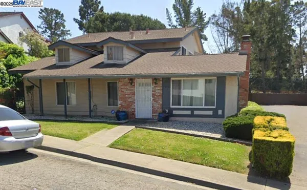 a view of a house with pool and chairs in a patio