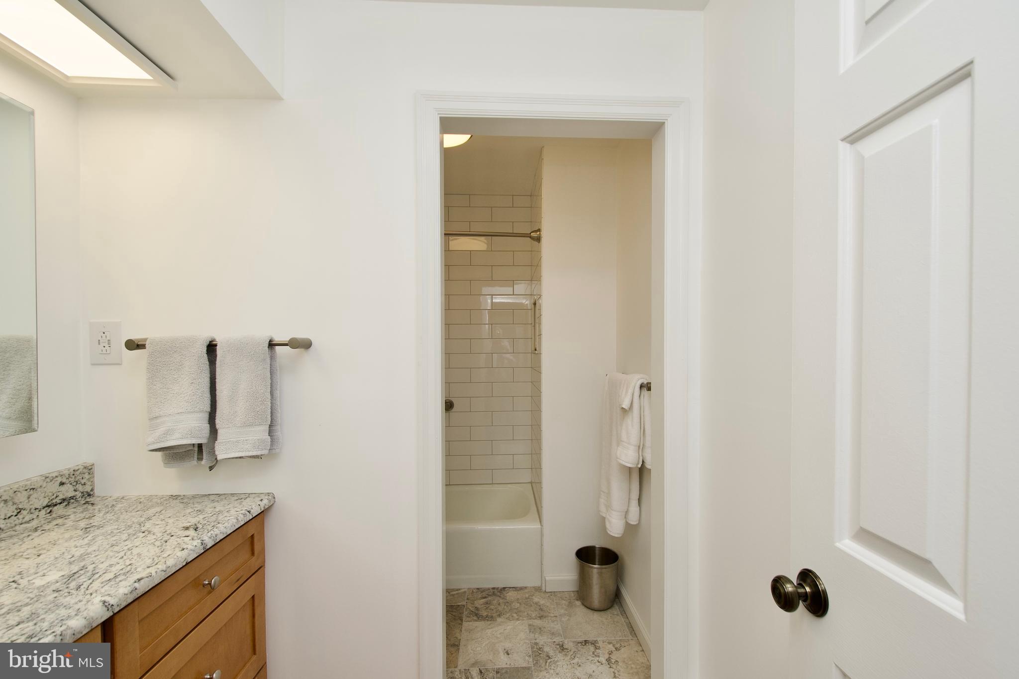 8005 Strauff Road, Unit 17 Towson, MD 21204 - Photo 26 of 49 a bathroom with a granite countertop sink and a mirror