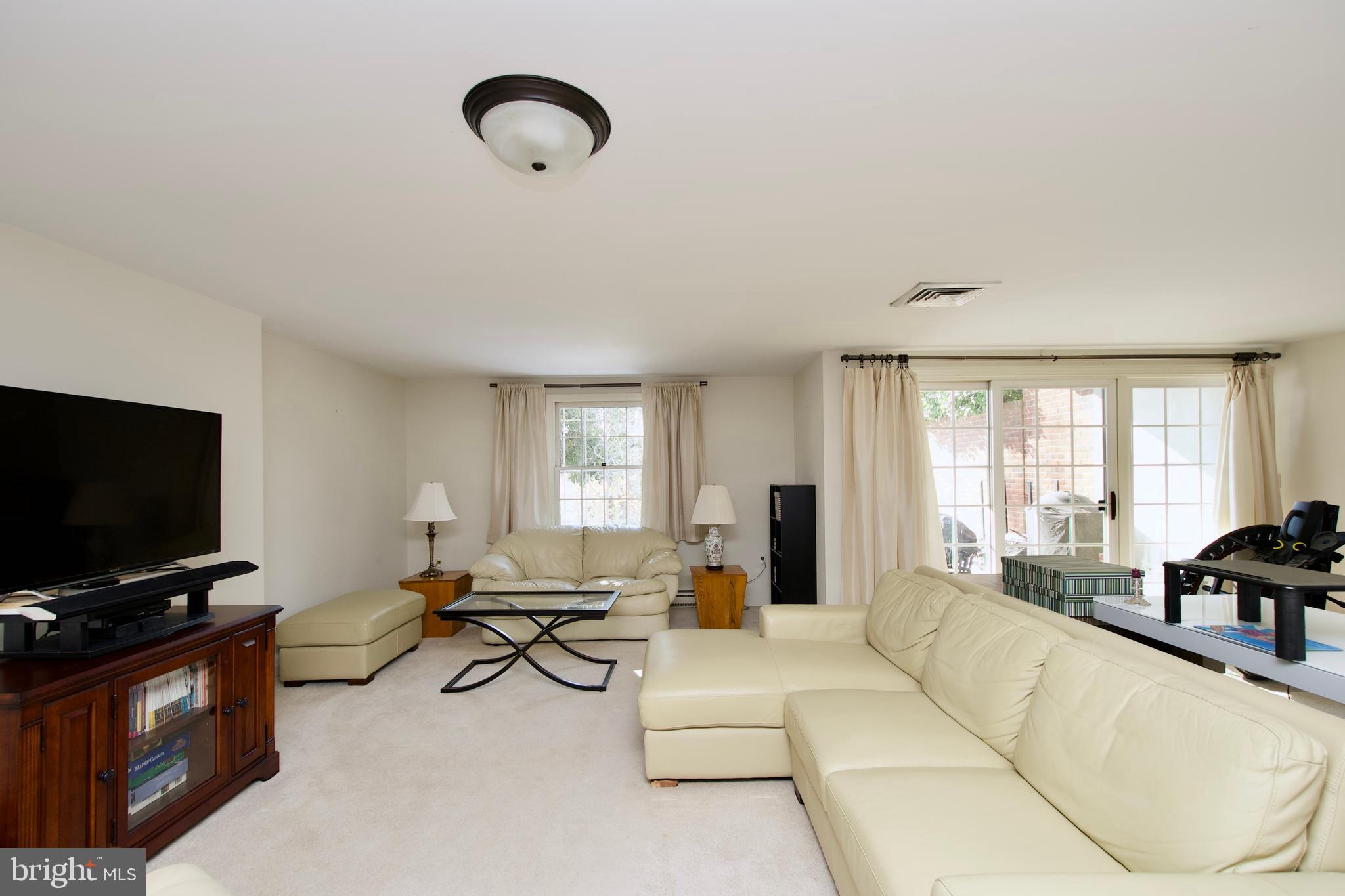 8005 Strauff Road, Unit 17 Towson, MD 21204 - Photo 42 of 49 a living room with furniture and a flat screen tv