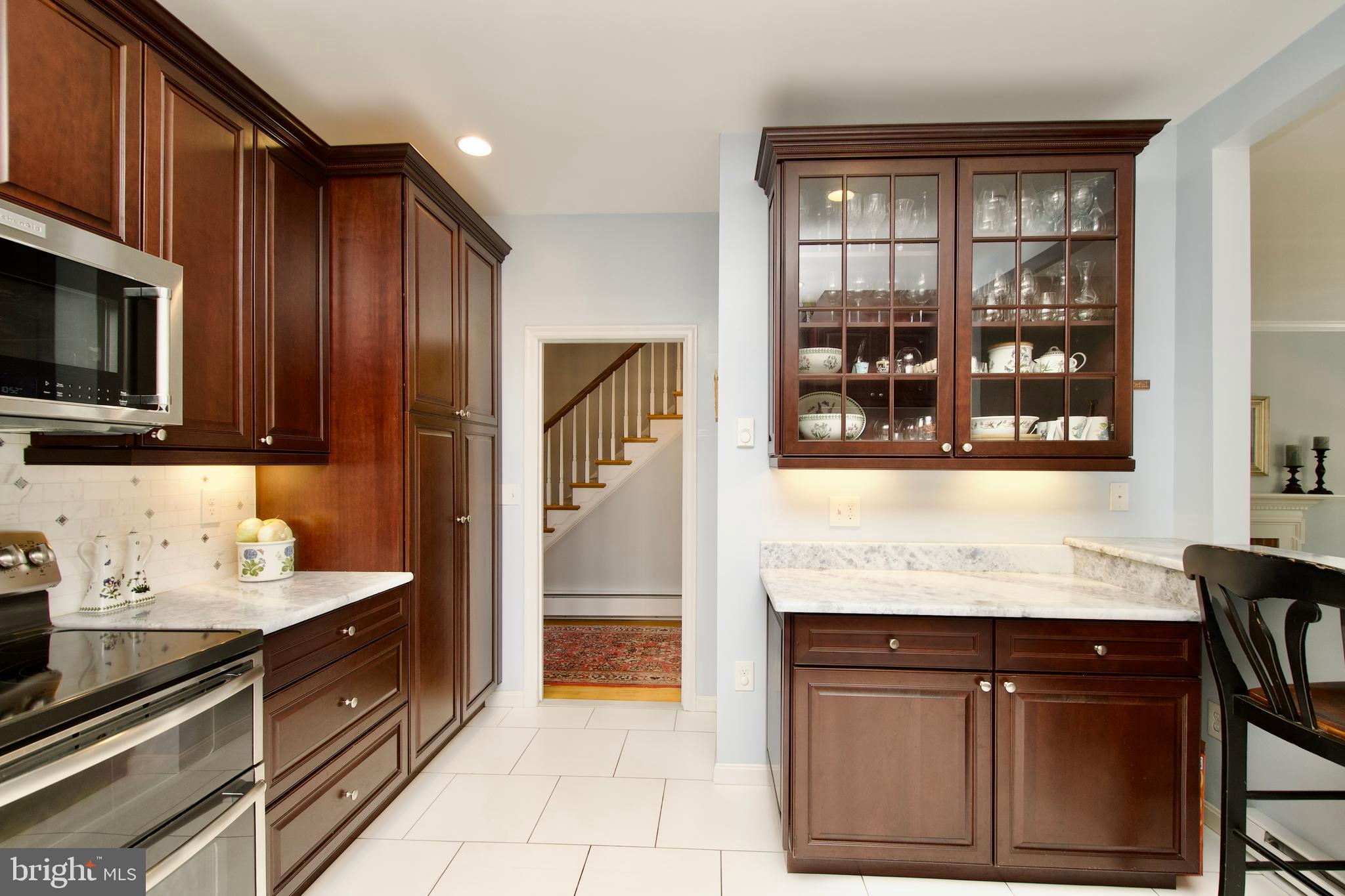 8005 Strauff Road, Unit 17 Towson, MD 21204 - Photo 6 of 49 a kitchen with stainless steel appliances granite countertop wooden cabinets and a stove top oven