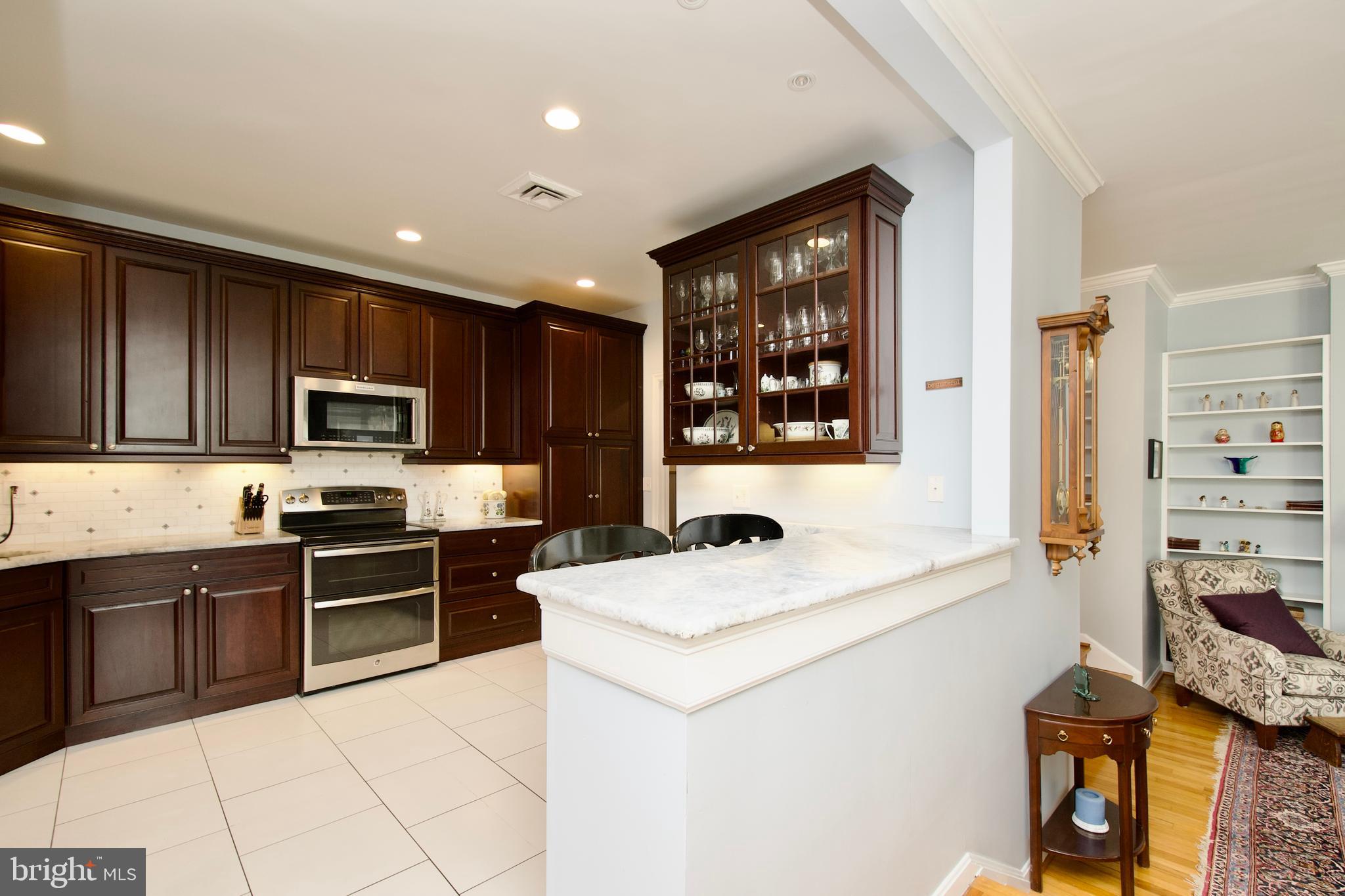 8005 Strauff Road, Unit 17 Towson, MD 21204 - Photo 8 of 49 a kitchen with stainless steel appliances granite countertop a sink stove and refrigerator