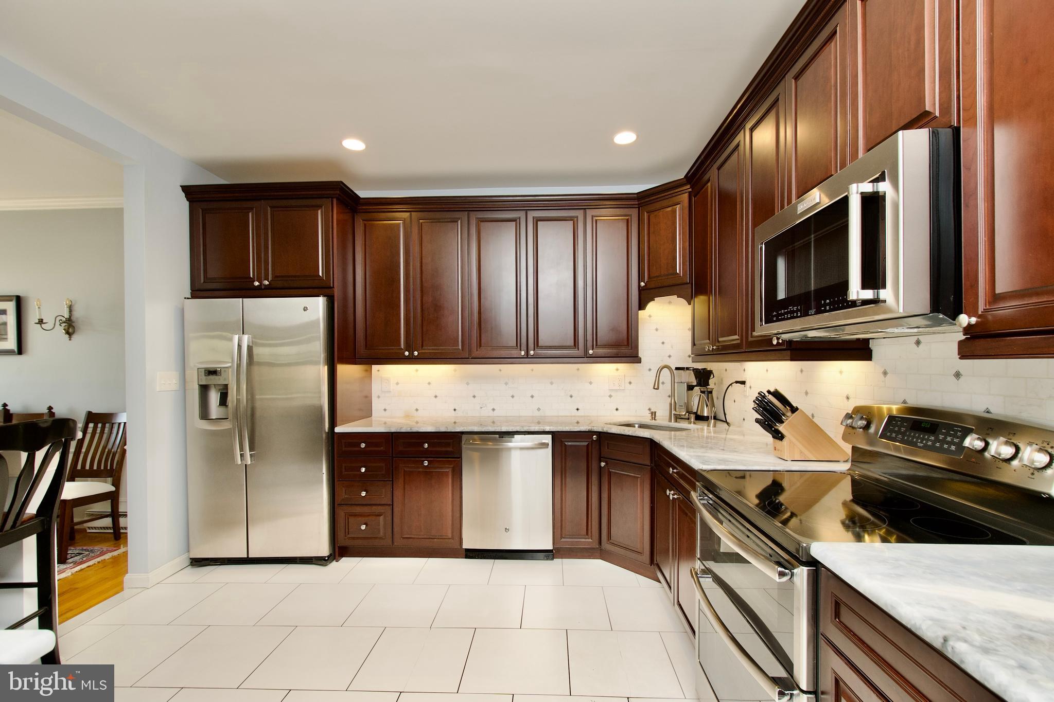 8005 Strauff Road, Unit 17 Towson, MD 21204 - Photo 10 of 49 a kitchen with a sink a stove and a refrigerator