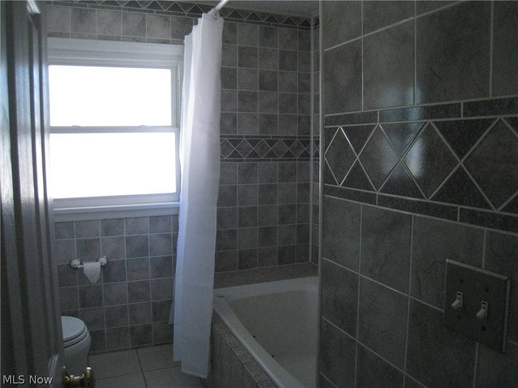 7160 Liberty Road Solon, OH 44139 - Photo 14 of 26 Second floor full bathroom done in ceramic and a jetted tub.