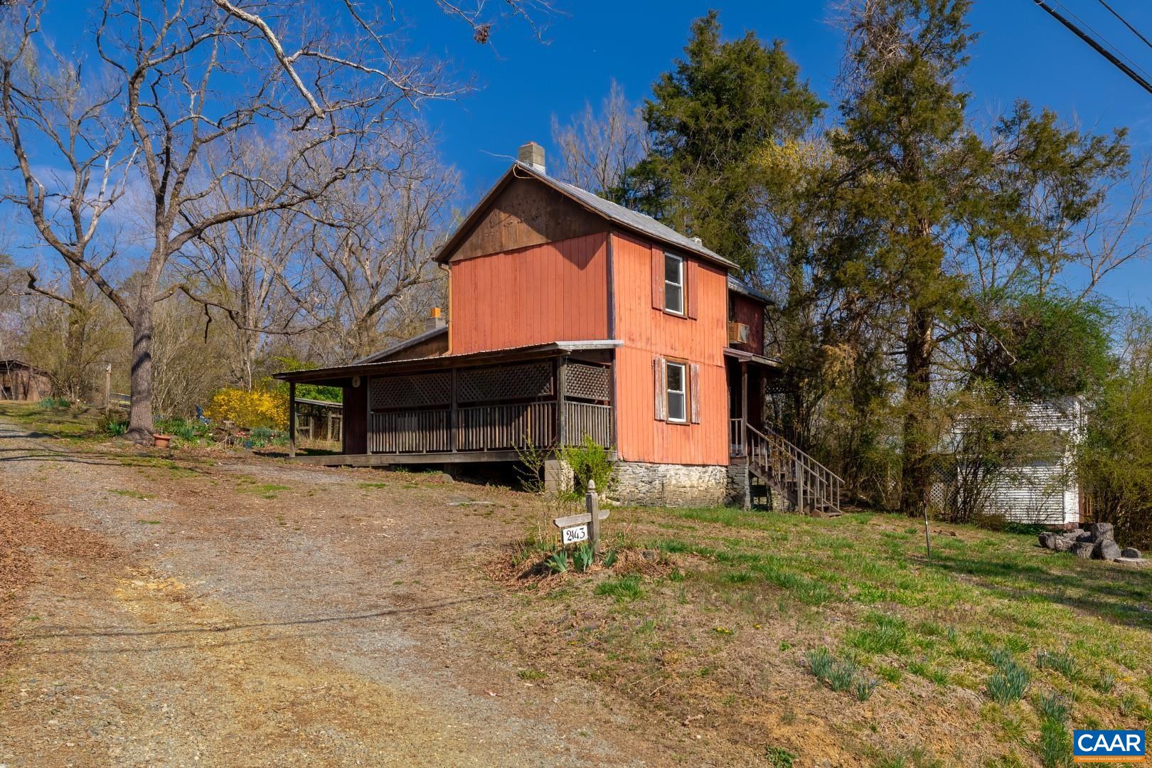 a front view of house with yard and trees