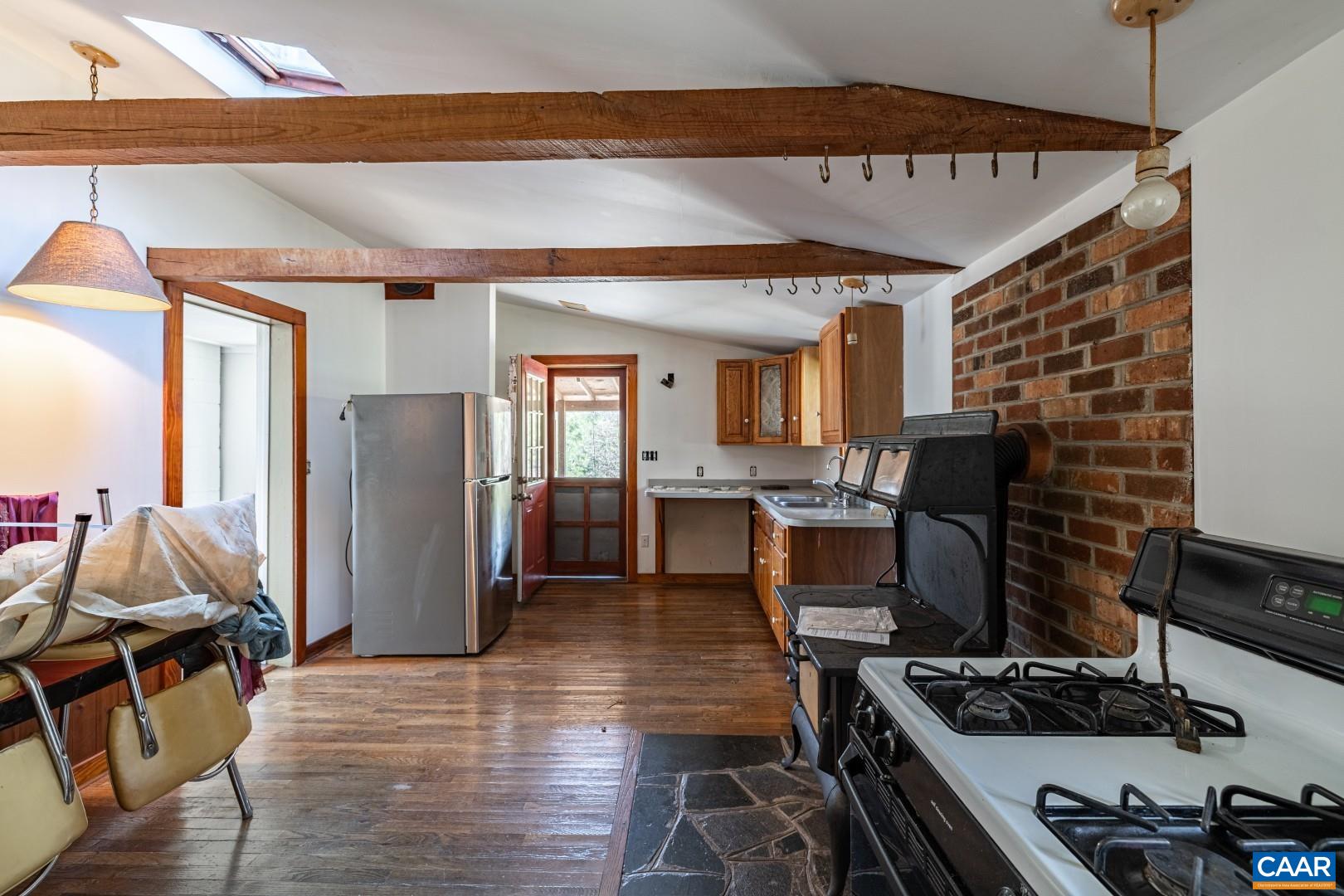 2143 Salem Road Schuyler, VA 22969 - Photo 19 of 36 a kitchen with stainless steel appliances granite countertop a stove refrigerator and wooden floor