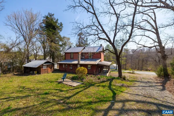 a view of a house with snow on the side of the road