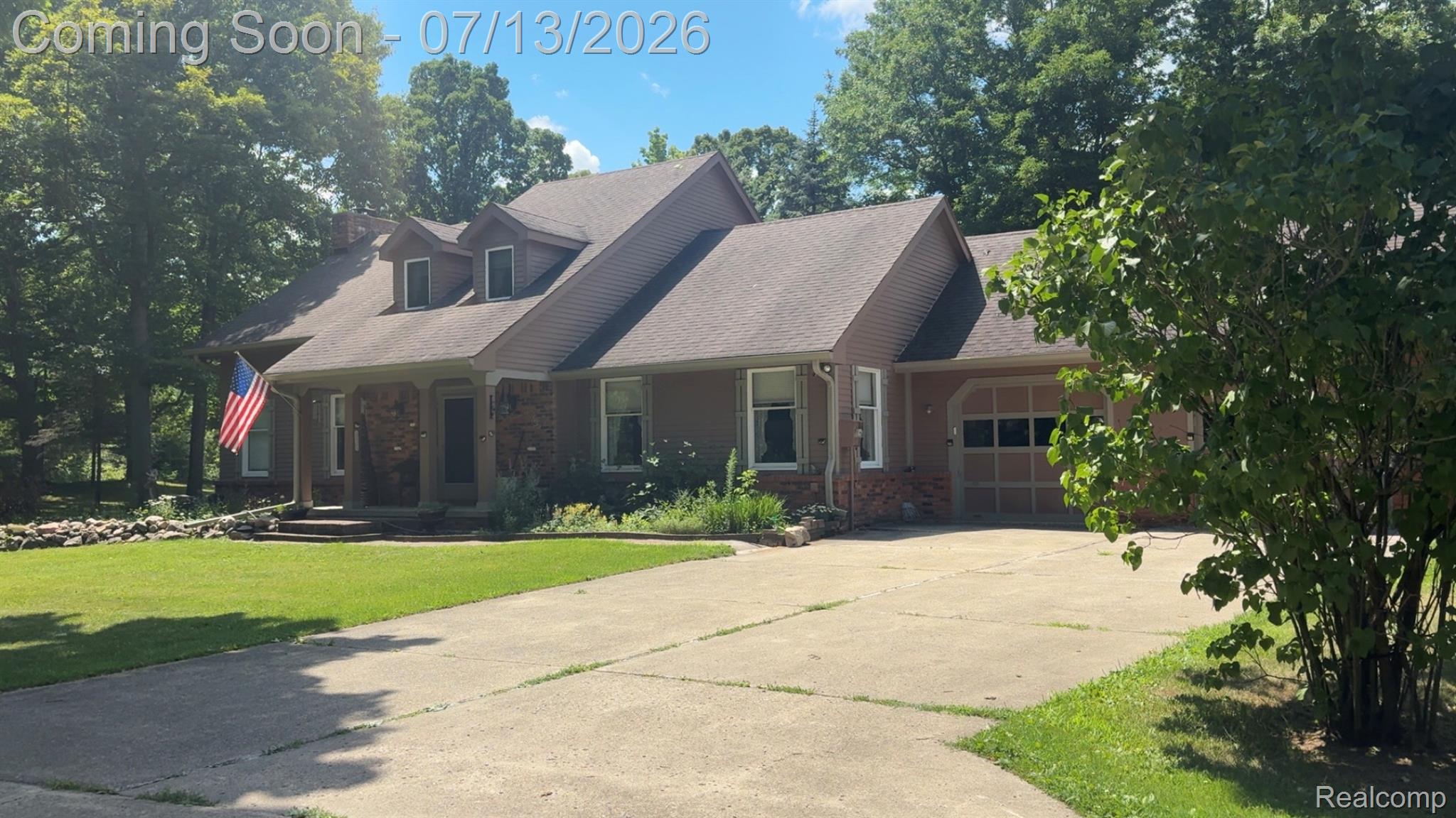 3284 Pratt Road Metamora, MI 48455 - Photo 1 of 2 Craftsman-style residence featuring a two-car garage, dormer windows, stone facade accents, and a covered front entry