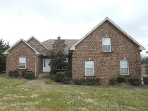 205 Lawrence Lane Springfield, TN 37172 - Photo 1 of 19 a view of a brick house next to a yard with large trees