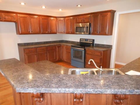 205 Lawrence Lane Springfield, TN 37172 - Photo 7 of 19 a kitchen with stainless steel appliances granite countertop a sink a stove and a microwave with granite countertops