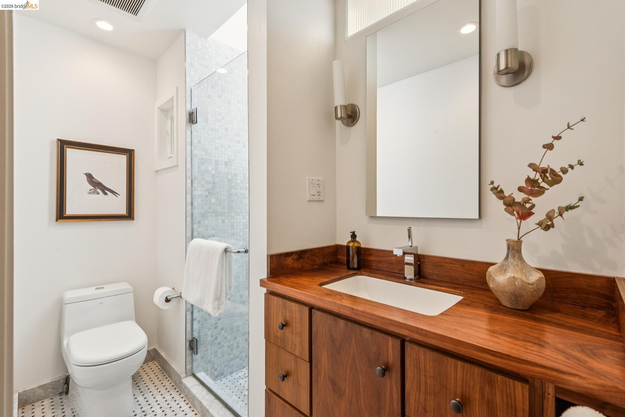 1490 Arch Street Berkeley, CA 94708 - Photo 22 of 57 a bathroom with a granite countertop sink a toilet and a mirror