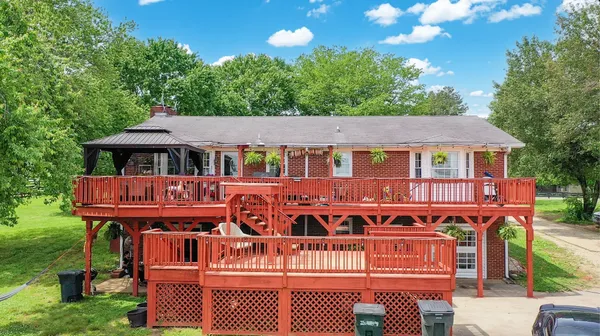 a front view of a house with yard swimming pool and outdoor seating