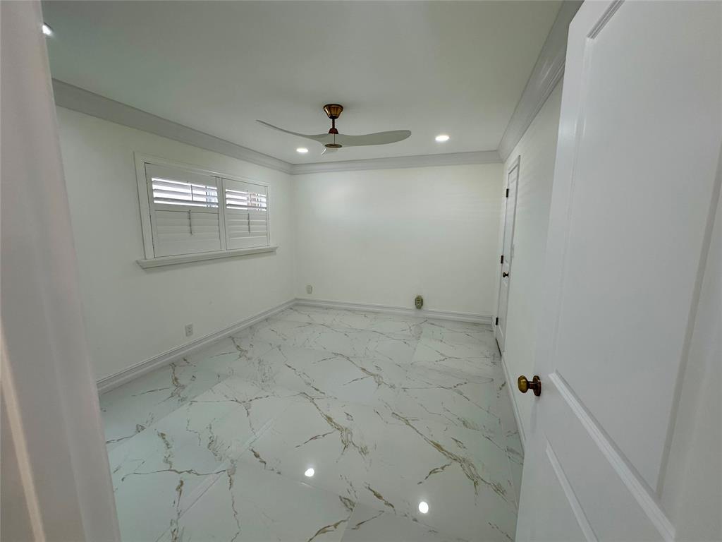 303 North Riverside Drive, Unit 1002 Pompano Beach, FL 33062 - Photo 18 of 27 an empty room with a ceiling fan and window