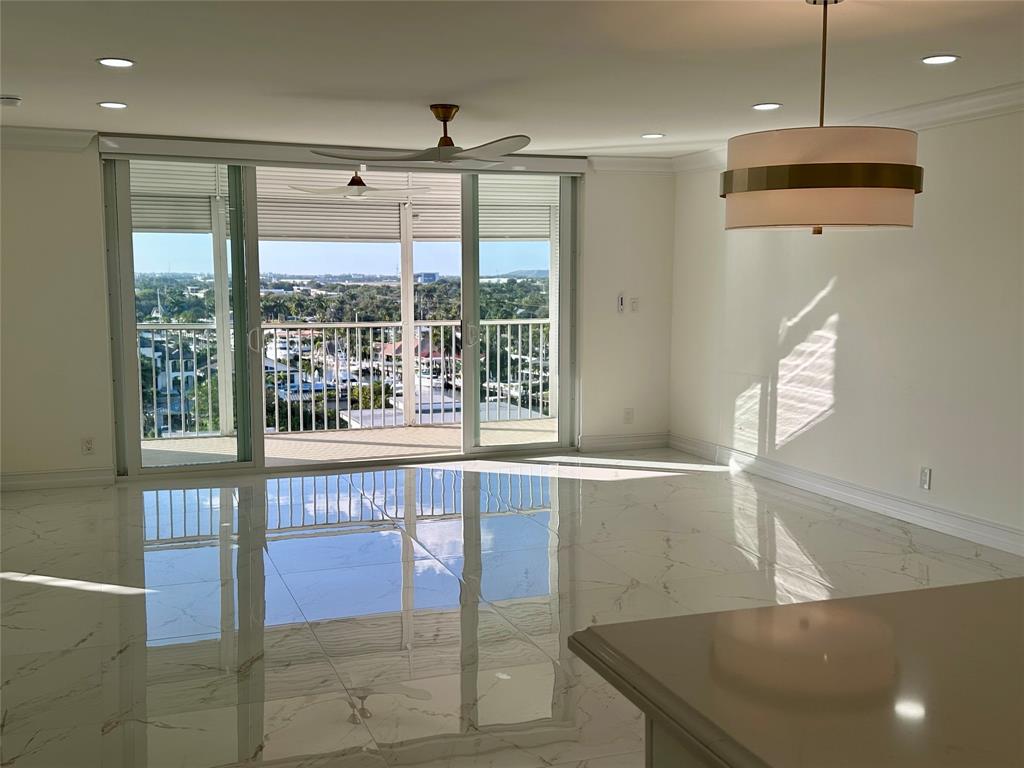 303 North Riverside Drive, Unit 1002 Pompano Beach, FL 33062 - Photo 2 of 27 a open kitchen with stainless steel appliances granite countertop a sink a flat screen tv and a large window