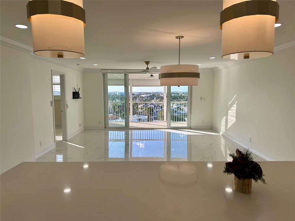 303 North Riverside Drive, Unit 1002 Pompano Beach, FL 33062 - Photo 3 of 27 a living room with furniture and a large window