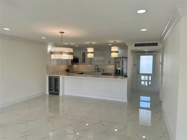 a large kitchen with kitchen island a sink stainless steel appliances and cabinets
