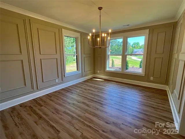 a view of a room with wooden floor and staircase
