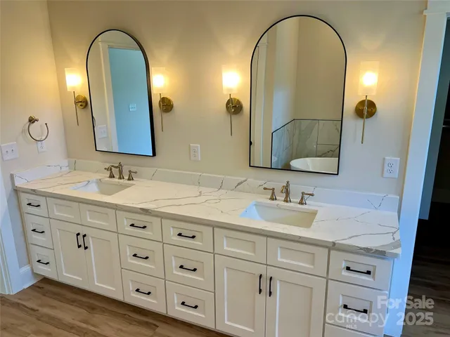 a bathroom with a sink mirror and shower