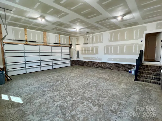 a front view of a house with a yard covered in snow
