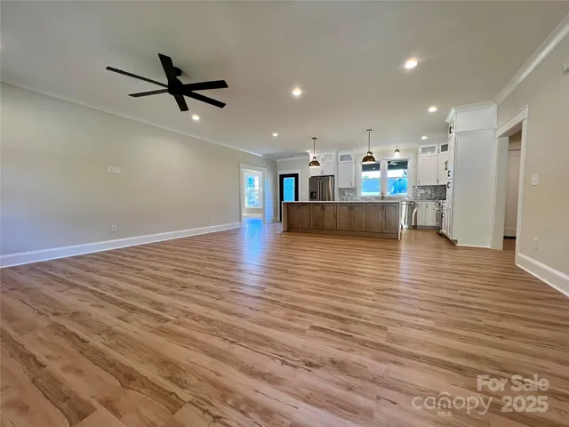 a view of a living room and kitchen with hardwood floor