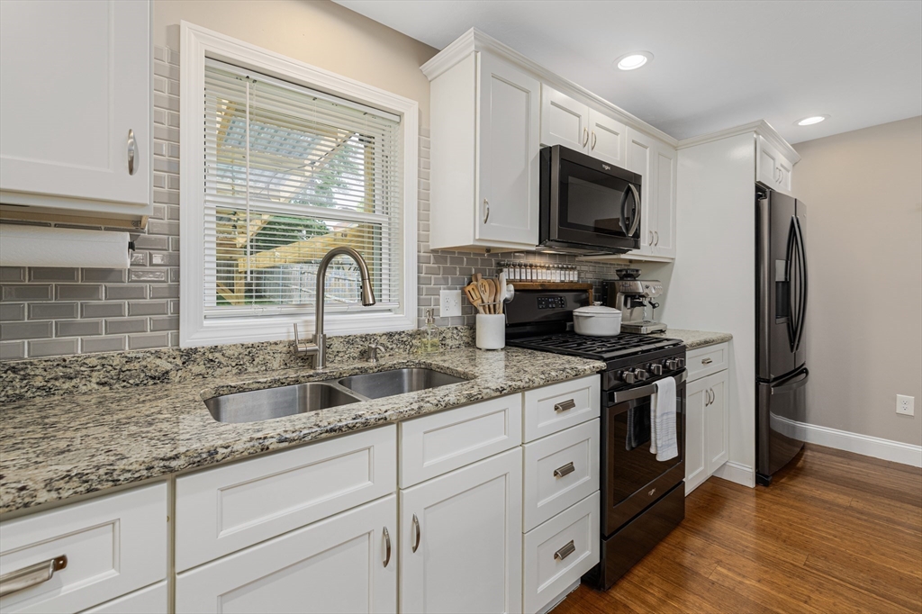 69 Denver Street Fall River, MA 02721 - Photo 16 of 35 a kitchen with stainless steel appliances granite countertop a sink stove and refrigerator