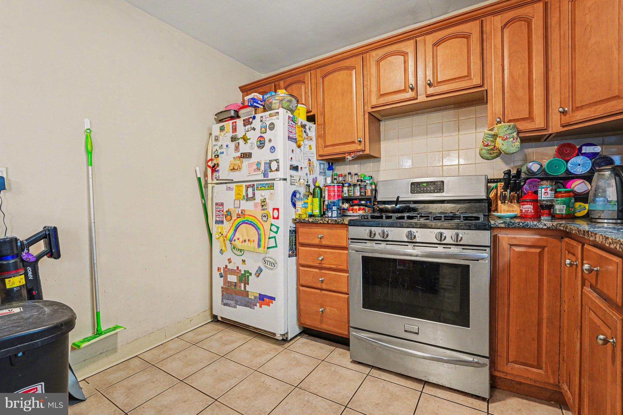 107 Allison Road Oreland, PA 19075 - Photo 14 of 54 a kitchen with stainless steel appliances granite countertop a stove a washer and dryer