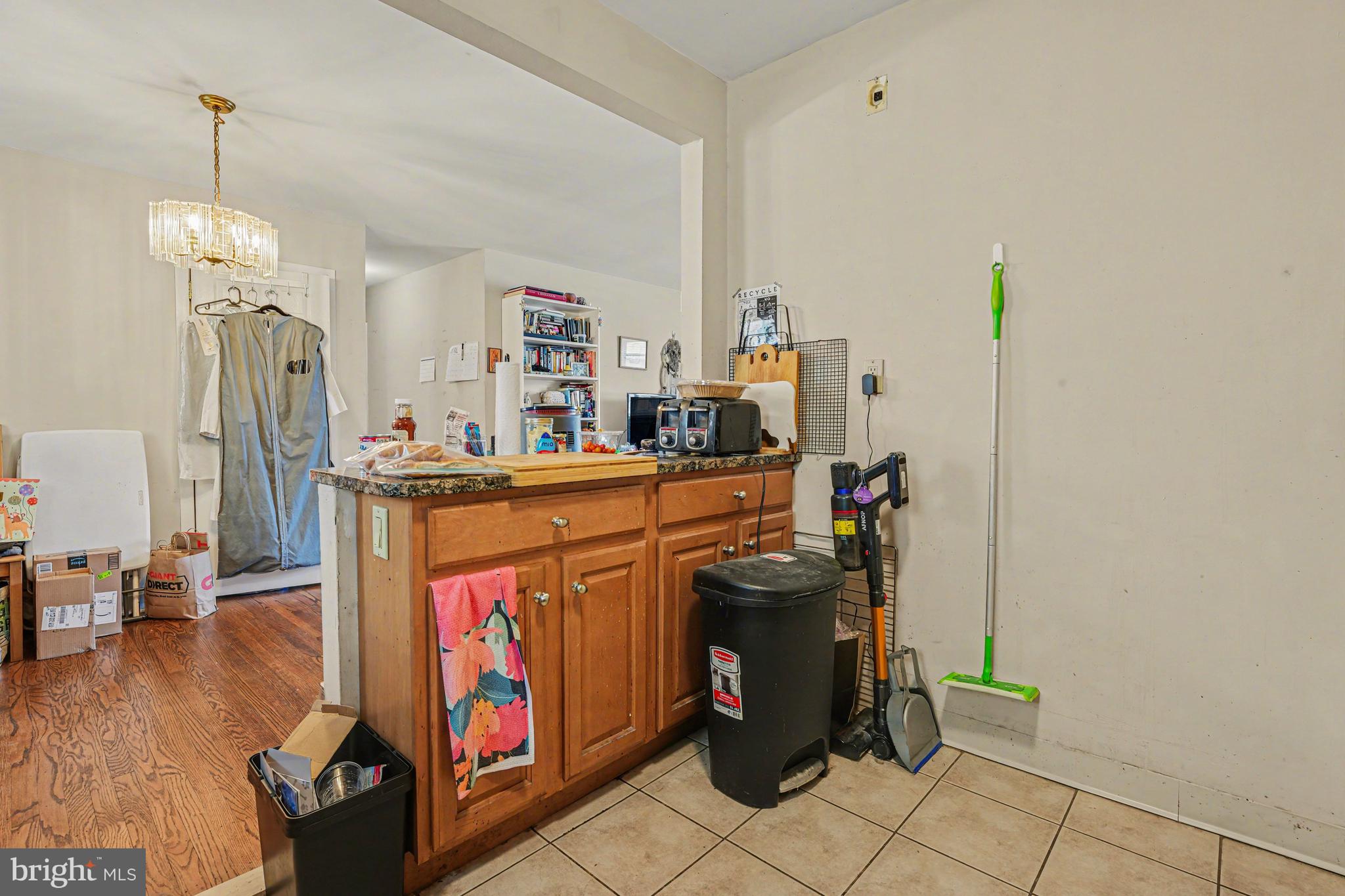 107 Allison Road Oreland, PA 19075 - Photo 15 of 54 a utility room with stainless steel appliances wooden floor and chandelier