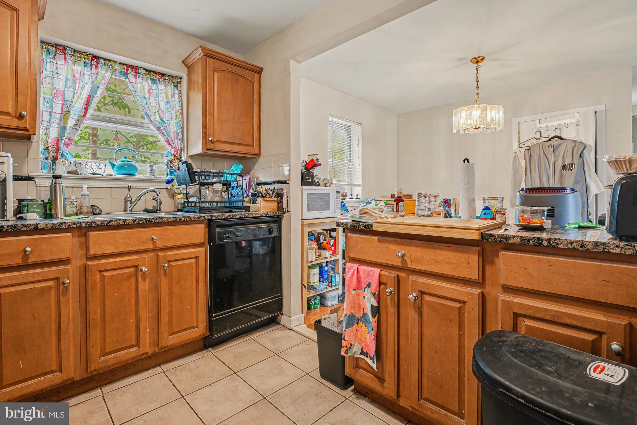 107 Allison Road Oreland, PA 19075 - Photo 16 of 54 a open kitchen with stainless steel appliances granite countertop a stove a sink dishwasher and cabinets with wooden floor