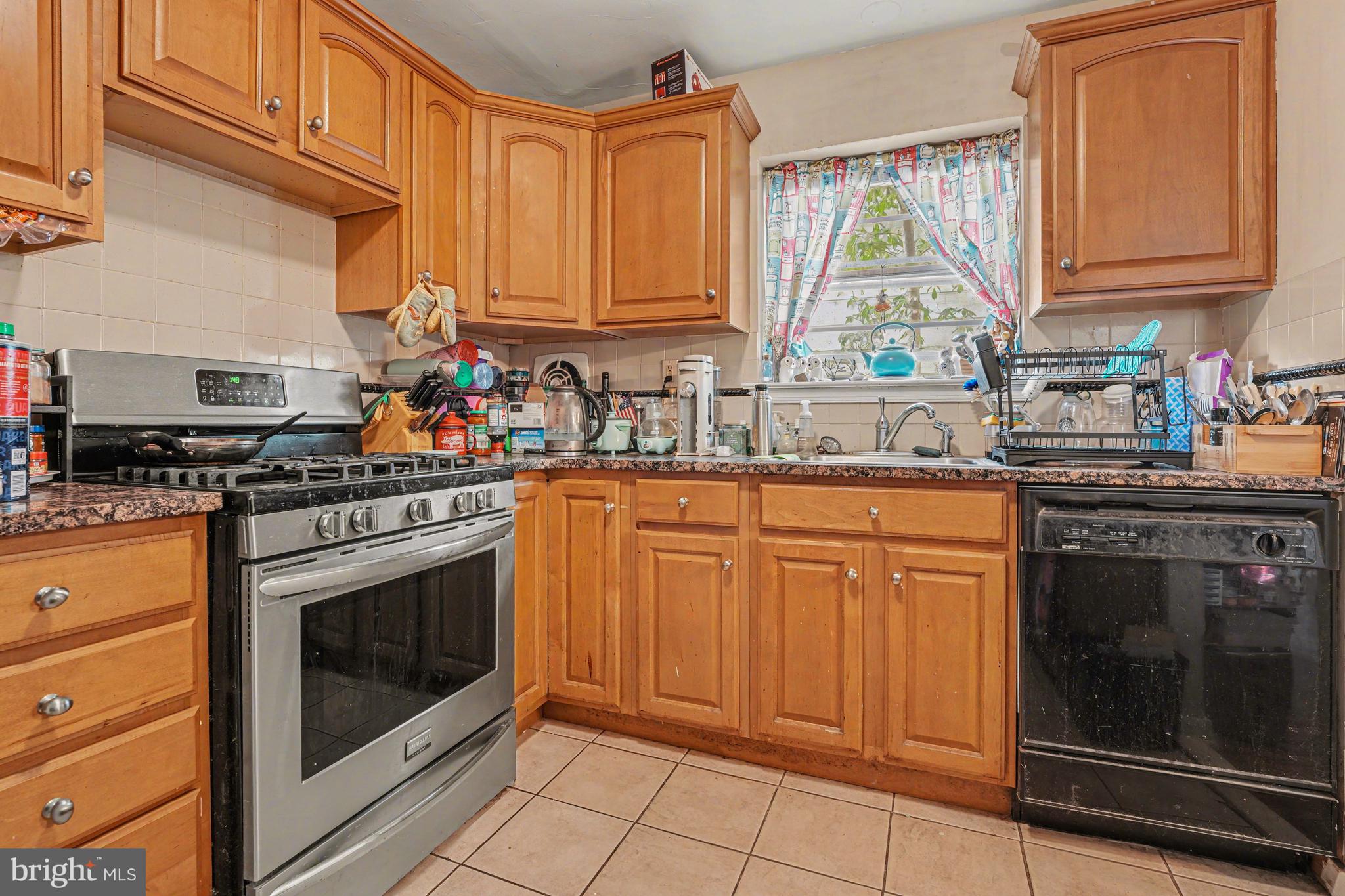 107 Allison Road Oreland, PA 19075 - Photo 17 of 54 a kitchen with stainless steel appliances granite countertop a stove sink and cabinets
