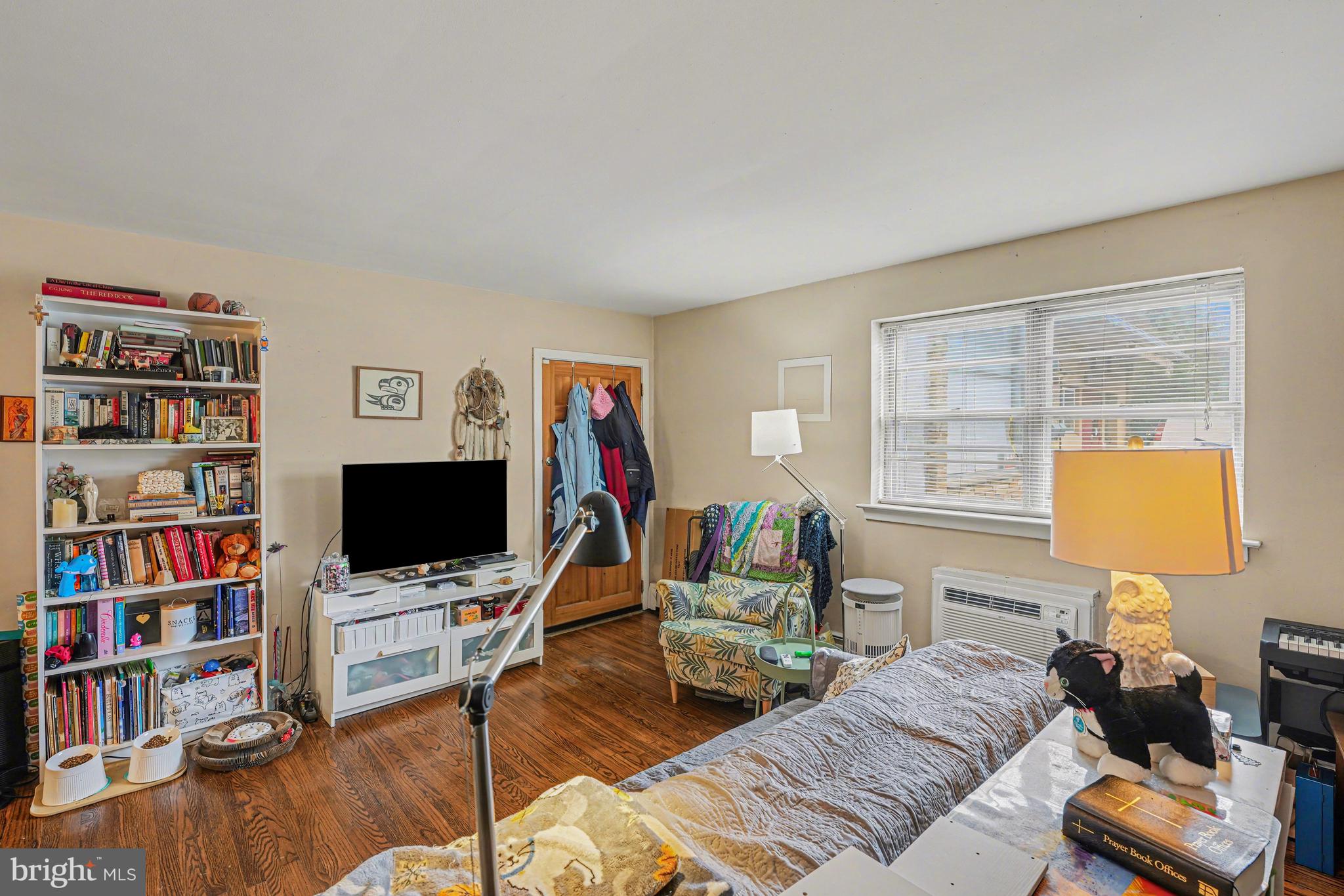 107 Allison Road Oreland, PA 19075 - Photo 21 of 54 a living room with furniture a bookshelf and a flat screen tv