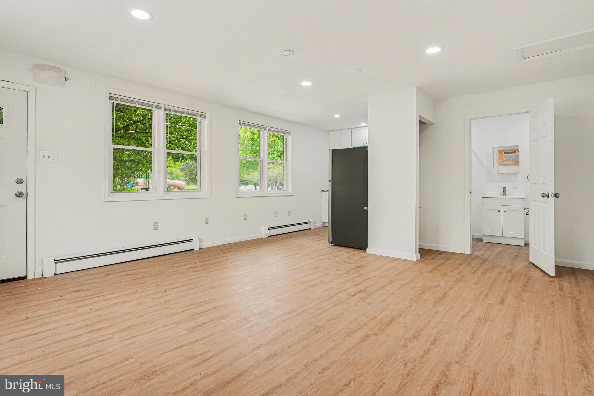 107 Allison Road Oreland, PA 19075 - Photo 6 of 54 an empty room with wooden floor and windows